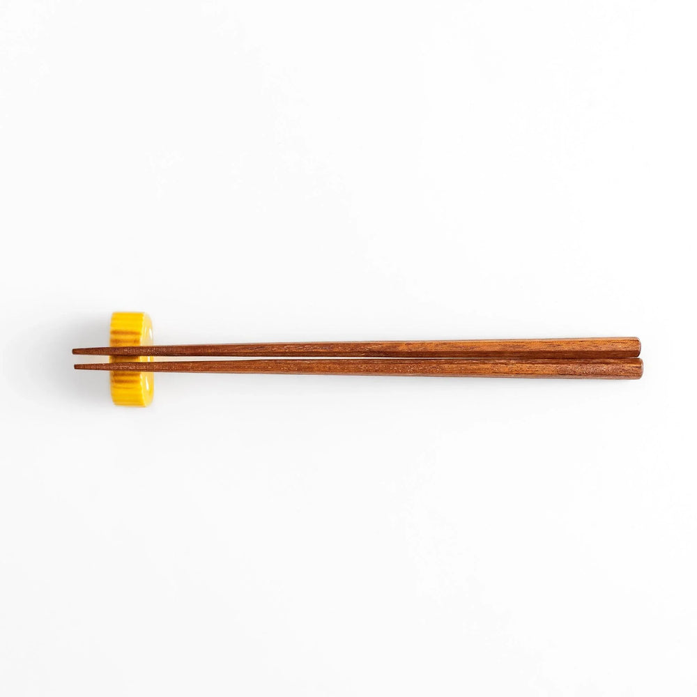 Japanese rolled omelette chopstick rest with bright yellow color adding fun and authentic dining accent.