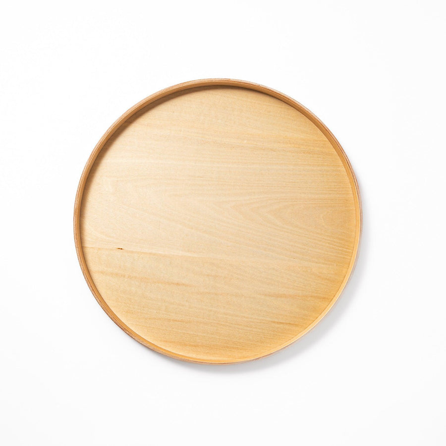 Minimalist Japanese round wooden tray with raised edge for serving tea snacks or organizing small items.