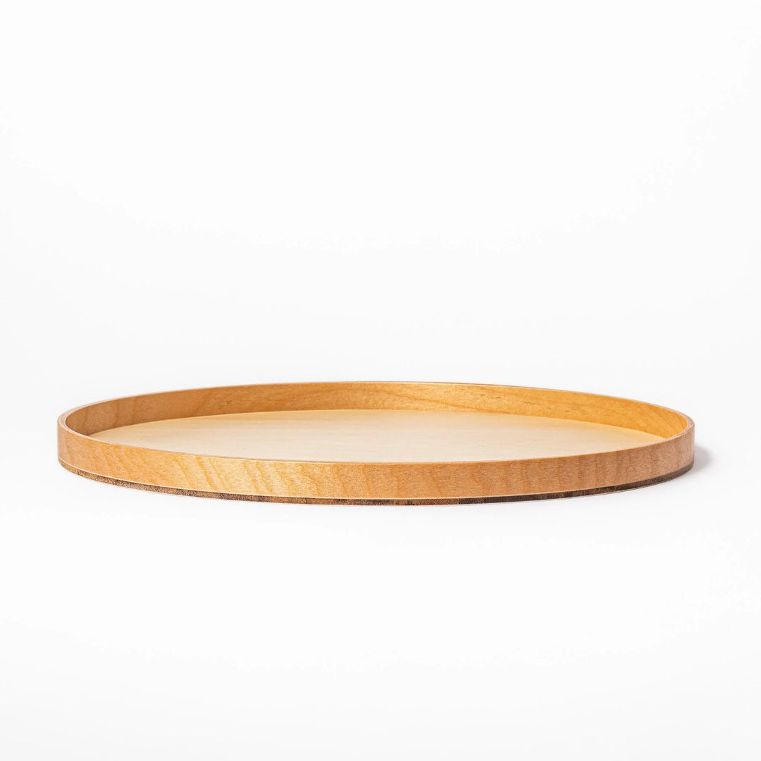 Minimalist Japanese round wooden tray with raised edge for serving tea snacks or organizing small items.