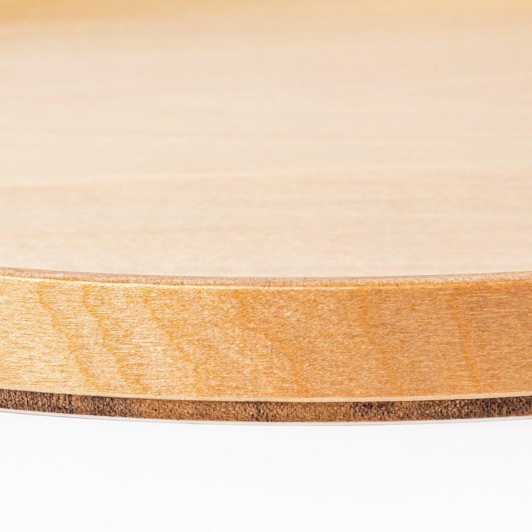 Minimalist Japanese round wooden tray with raised edge for serving tea snacks or organizing small items.