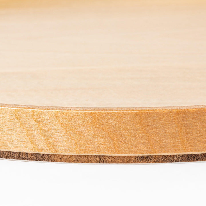 Minimalist Japanese round wooden tray with raised edge for serving tea snacks or organizing small items.