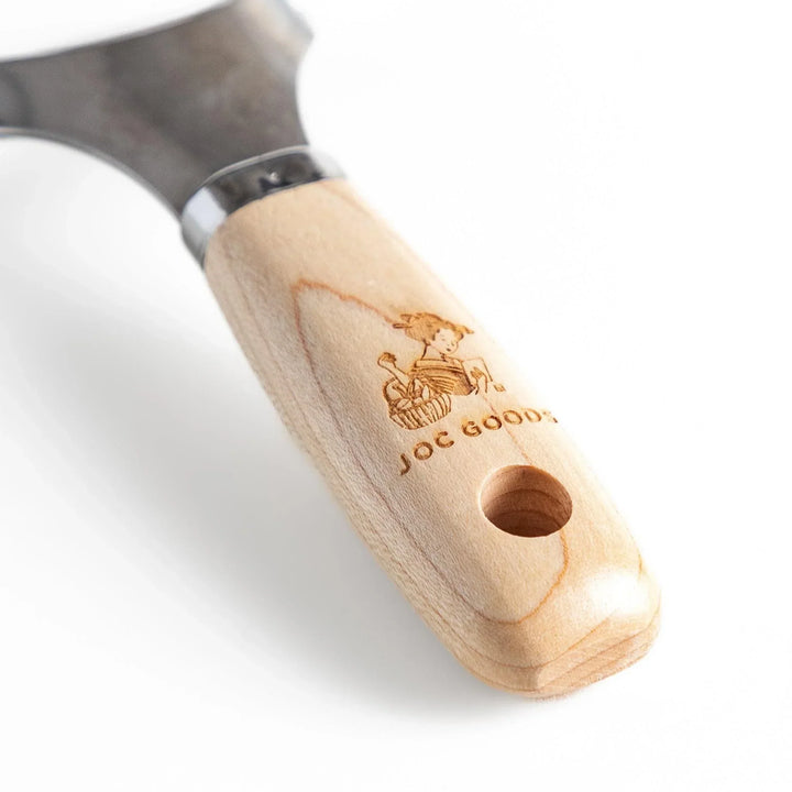 Japanese wood handle peeler with sharp stainless steel blade designed for smooth effortless vegetable peeling.