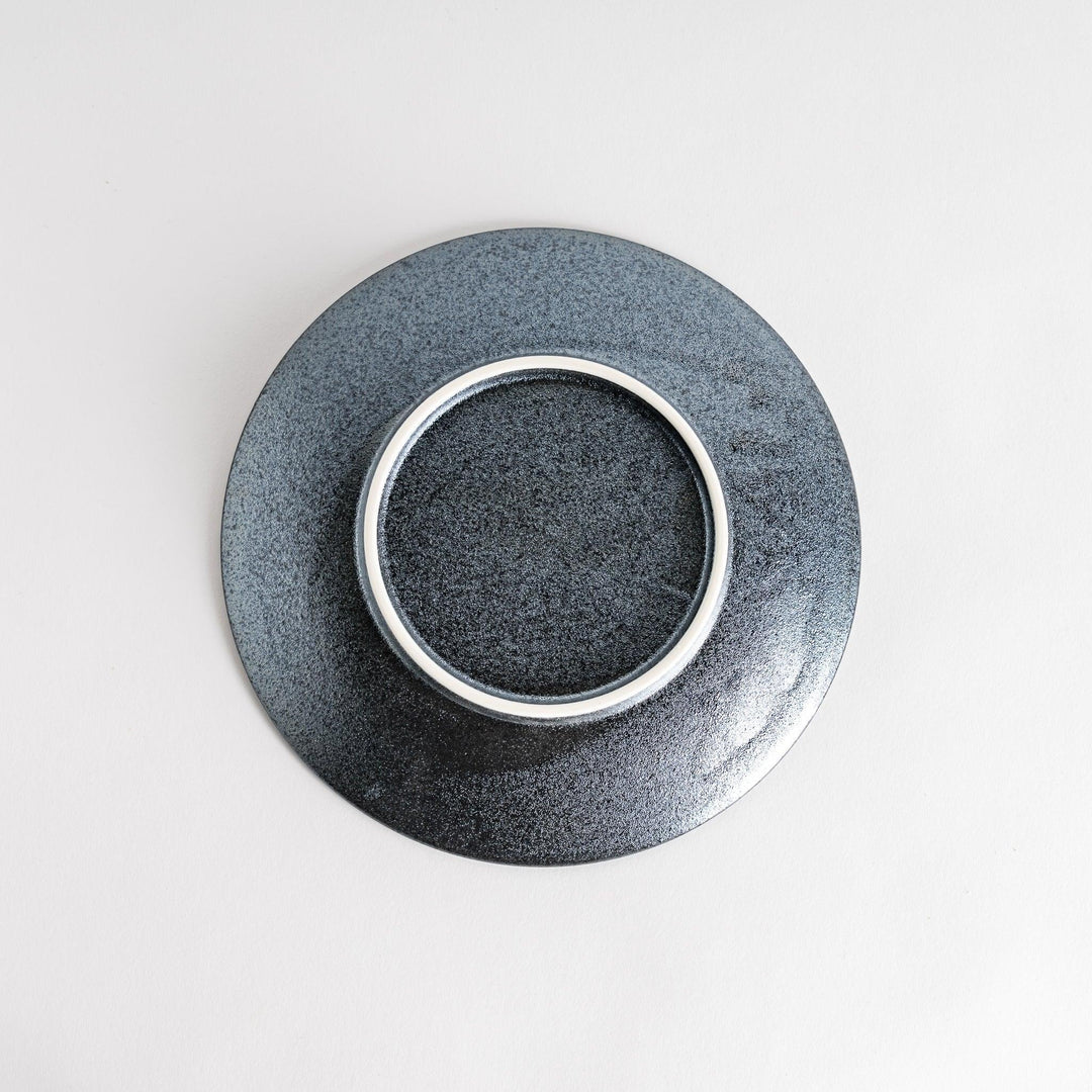 A round black salad plate with a subtle, rustic texture, ideal for modern table settings.