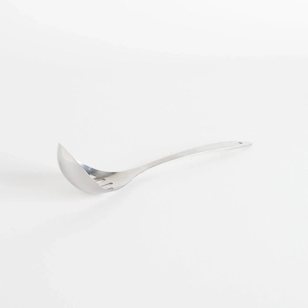 A stainless steel ladle with small drainage holes and a wide, deep scoop, designed for straining while serving.