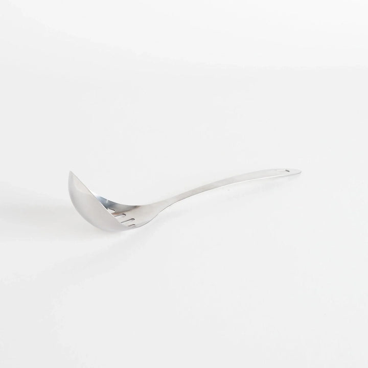 A stainless steel ladle with small drainage holes and a wide, deep scoop, designed for straining while serving.
