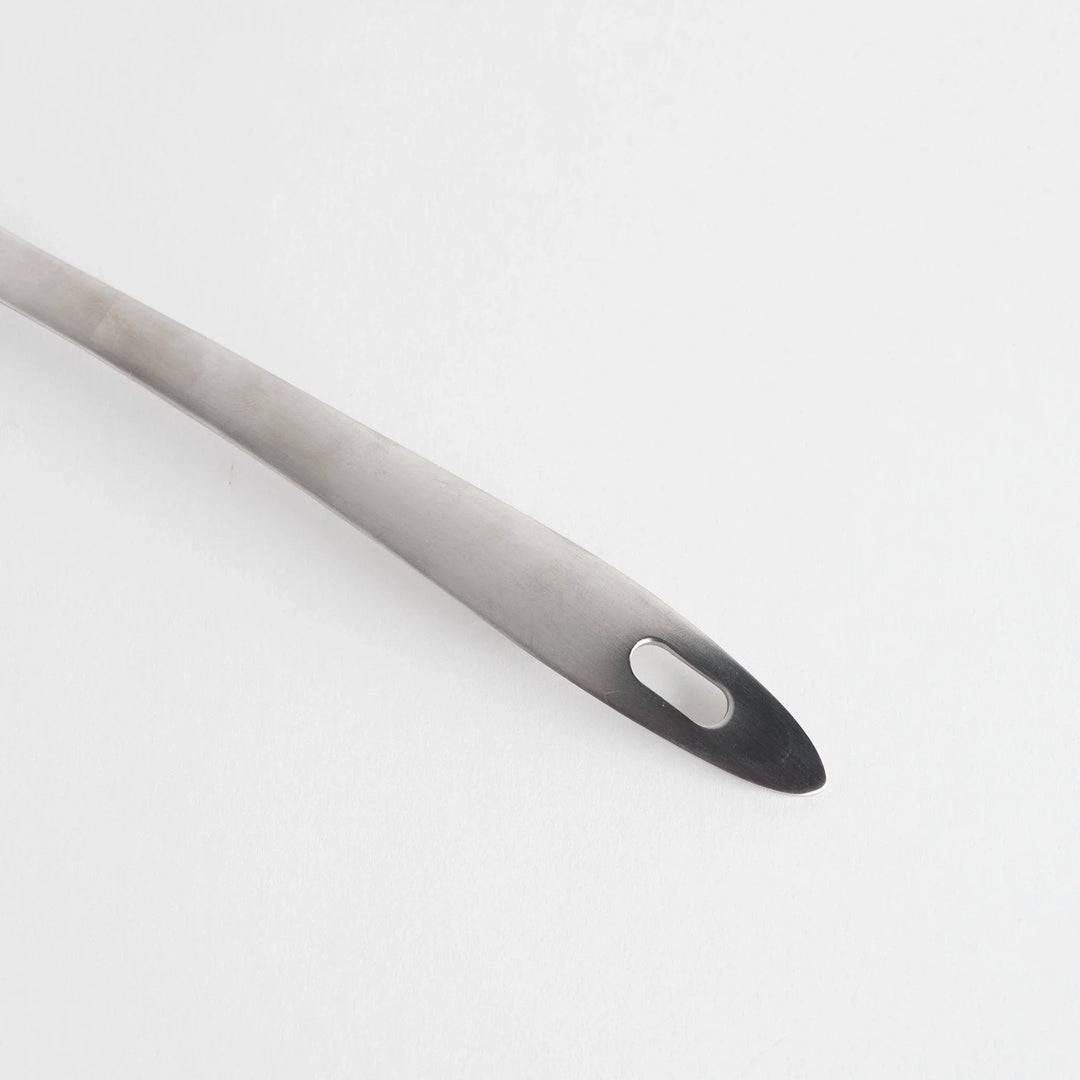 A stainless steel ladle with small drainage holes and a wide, deep scoop, designed for straining while serving.