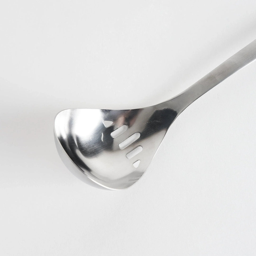 A stainless steel ladle with small drainage holes and a wide, deep scoop, designed for straining while serving.