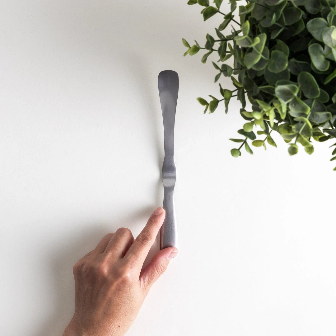 Stainless steel jam spreader with a sleek, double-ended design.