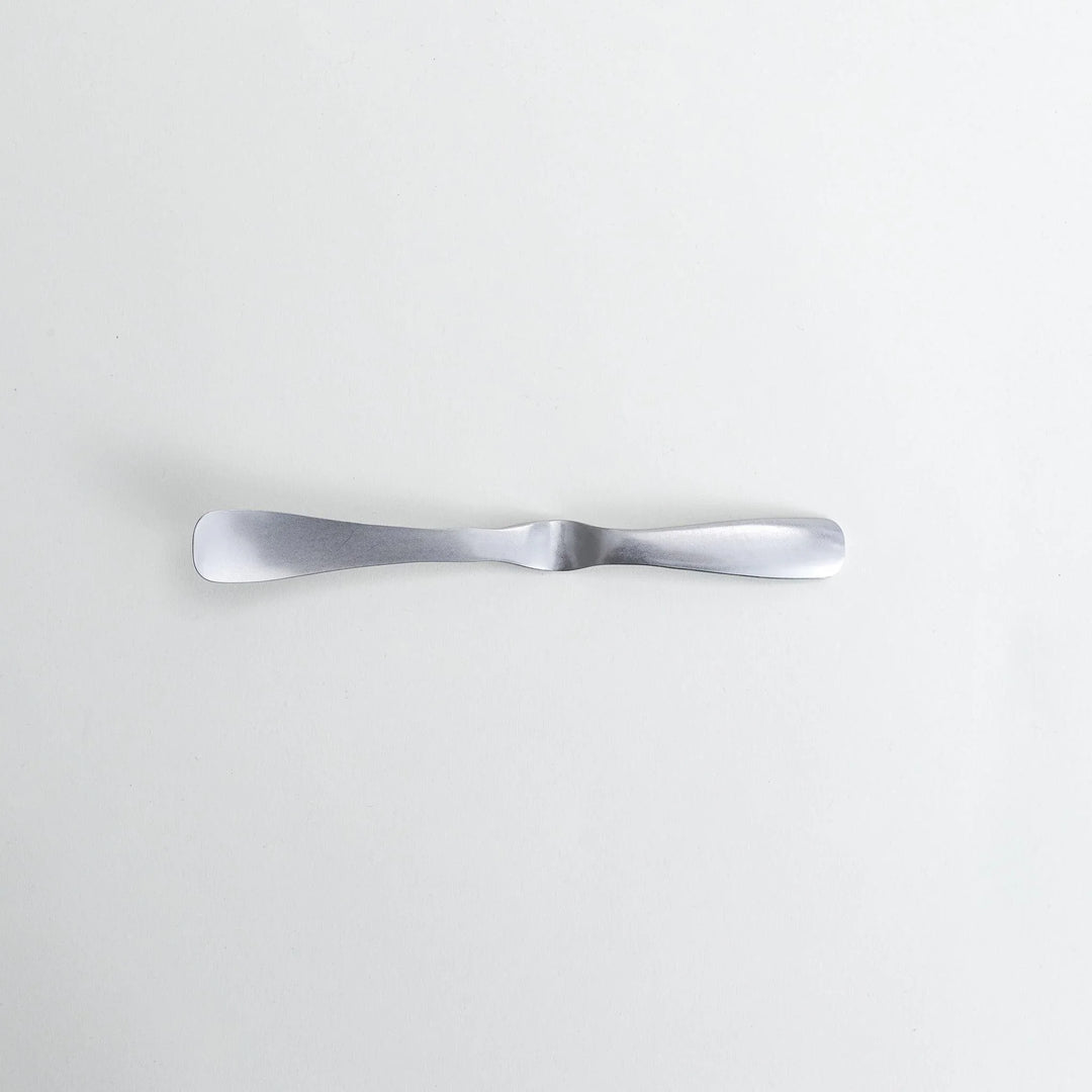 Stainless steel jam spreader with a sleek, double-ended design.