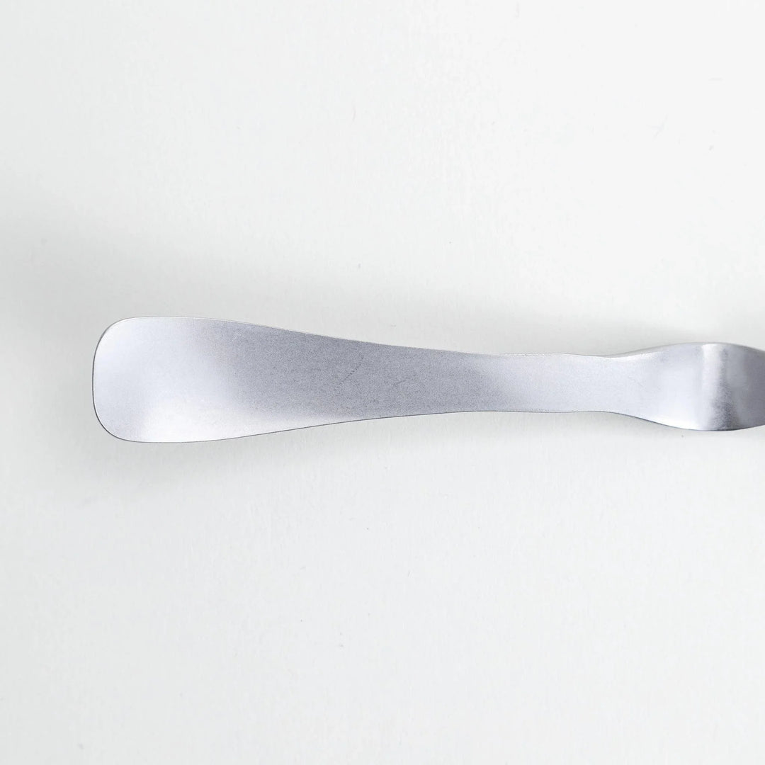 Stainless steel jam spreader with a sleek, double-ended design.