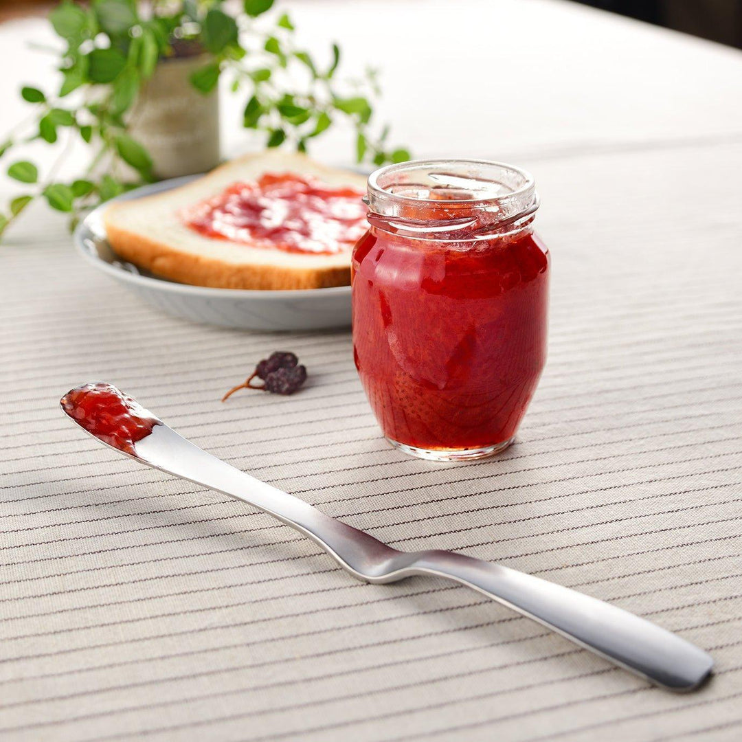 Stainless steel jam spreader with a sleek, double-ended design.
