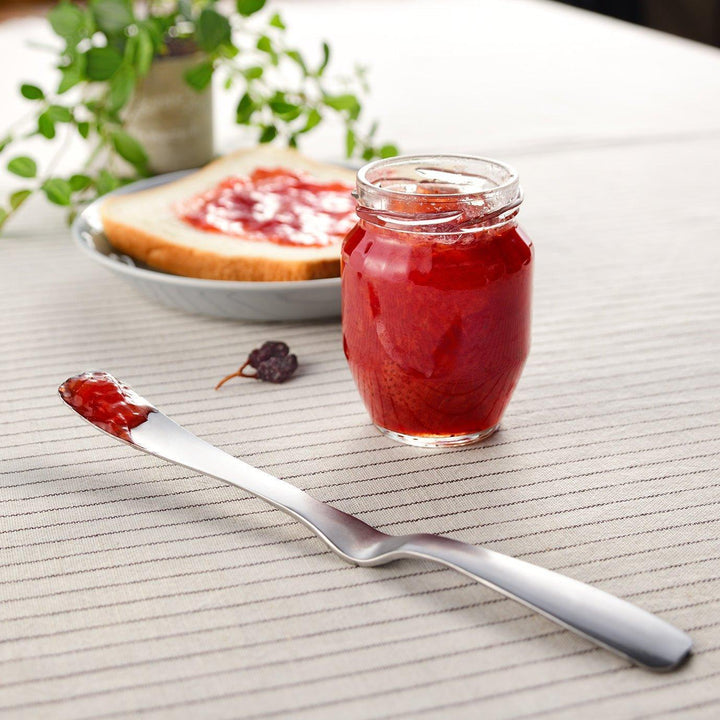 Stainless steel jam spreader with a sleek, double-ended design.