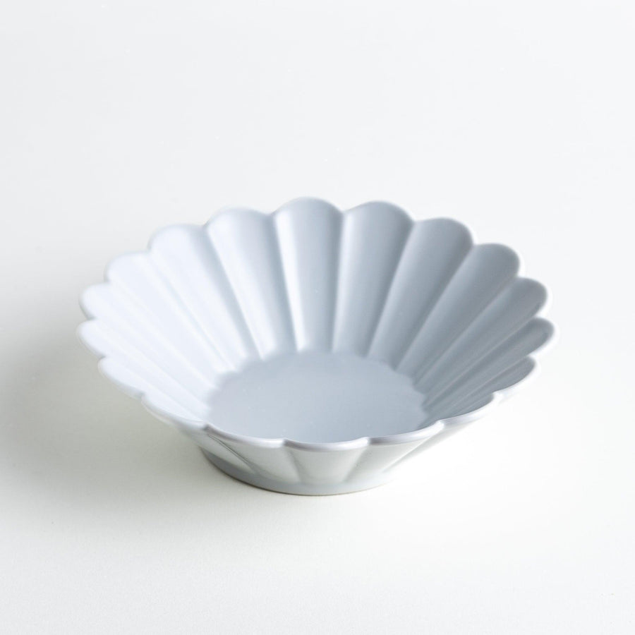 A white ceramic bowl featuring a fluted design.