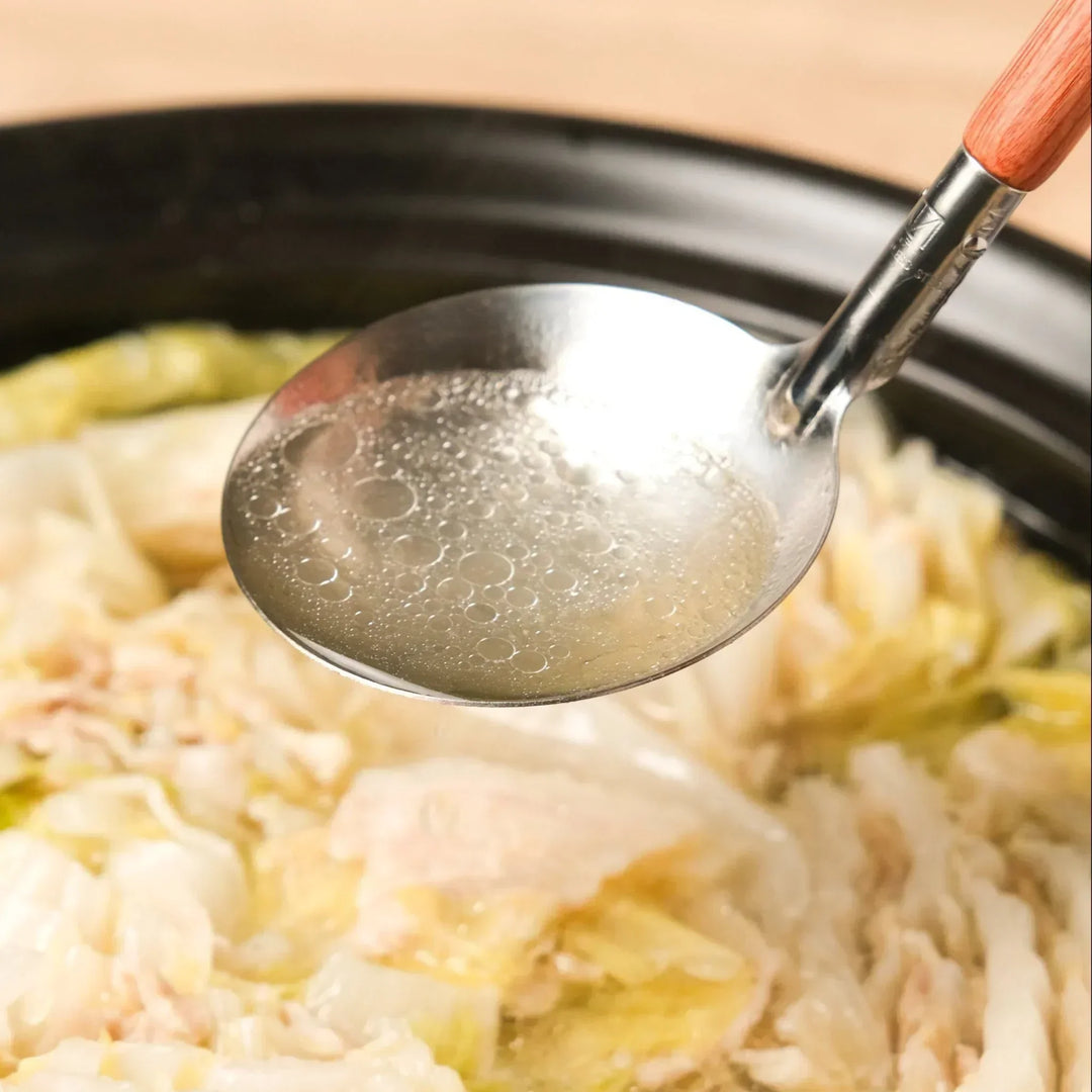 AUX stainless ladle for serving hot soups and stews directly from the pot, offering precision and balance.