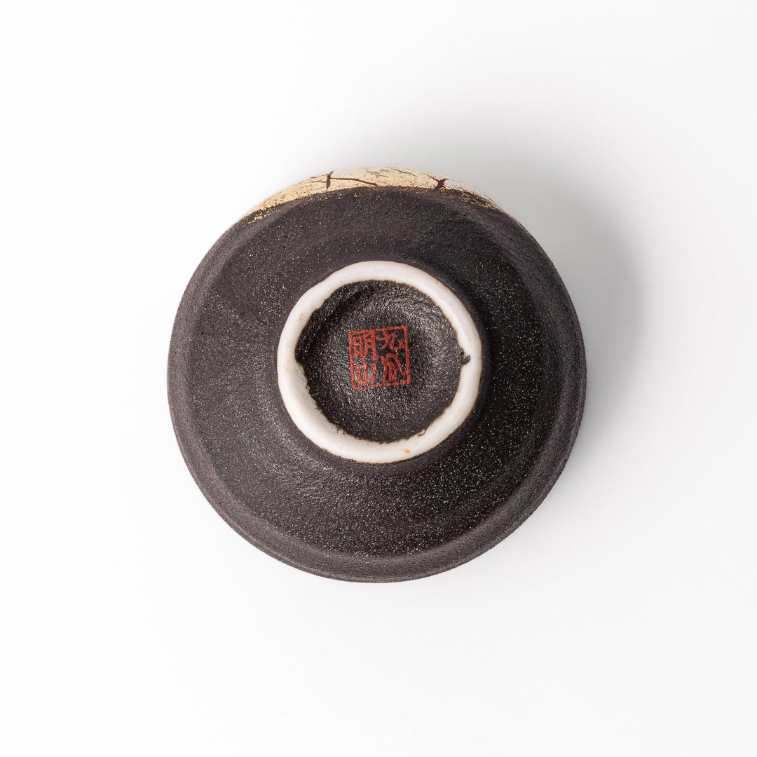 Black and gold Kutani sake set with spouted carafe and cups, blending Kintsugi art with modern elegance.