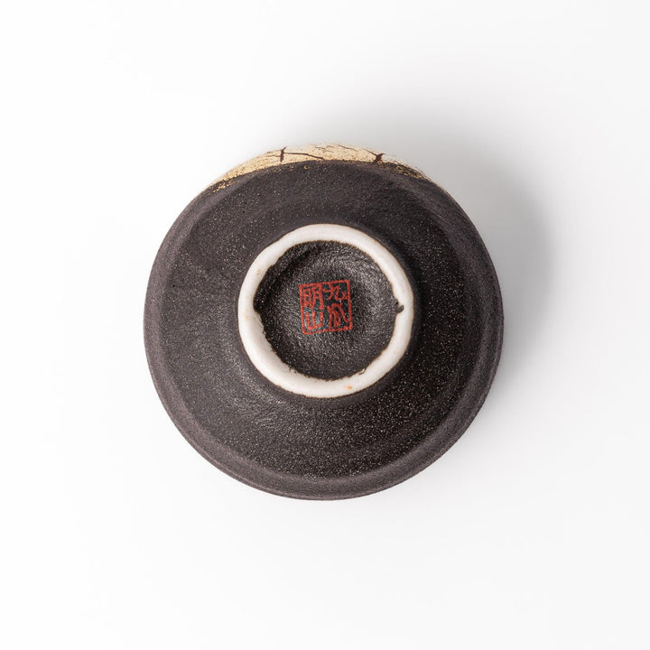 Black and gold Kutani sake set with spouted carafe and cups, blending Kintsugi art with modern elegance.