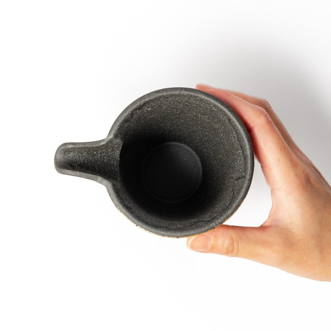 Black and gold Kutani sake set with spouted carafe and cups, blending Kintsugi art with modern elegance.