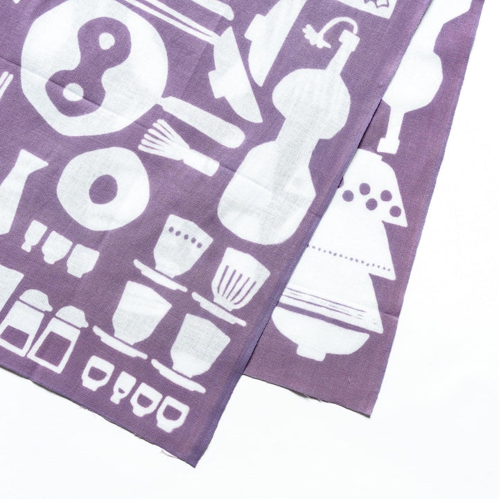 Purple tenugui towel with white kitchenware motifs like bowls and teapots in continuous pattern.