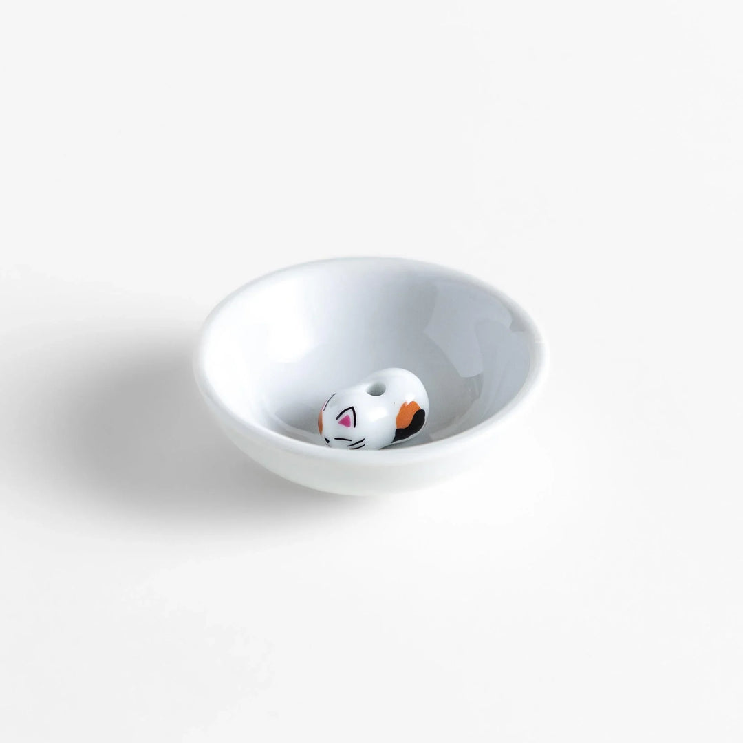 White ceramic incense holder with a small calico cat figurine inside the bowl, adding a touch of warmth to your daily rituals