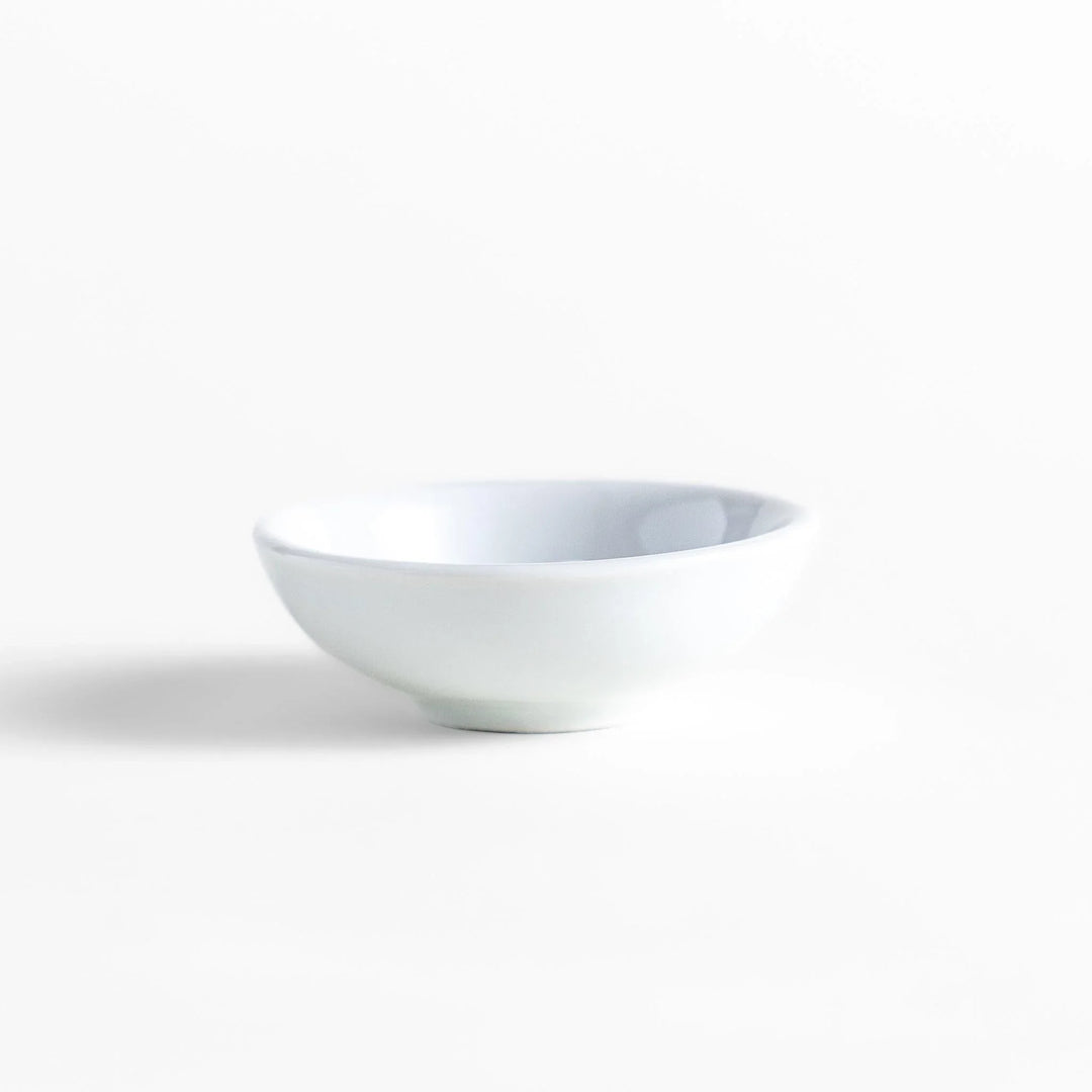 White ceramic incense holder with a small calico cat figurine inside the bowl, adding a touch of warmth to your daily rituals