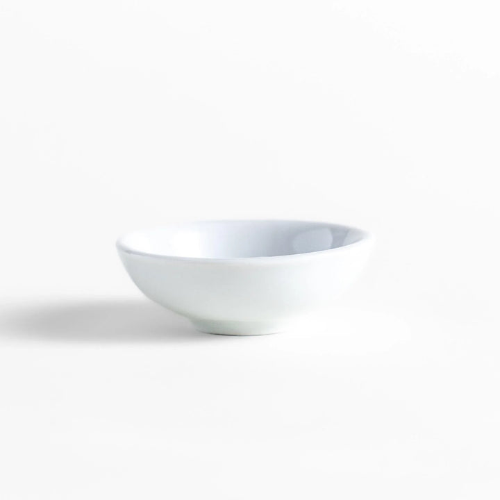 White ceramic incense holder with a small calico cat figurine inside the bowl, adding a touch of warmth to your daily rituals