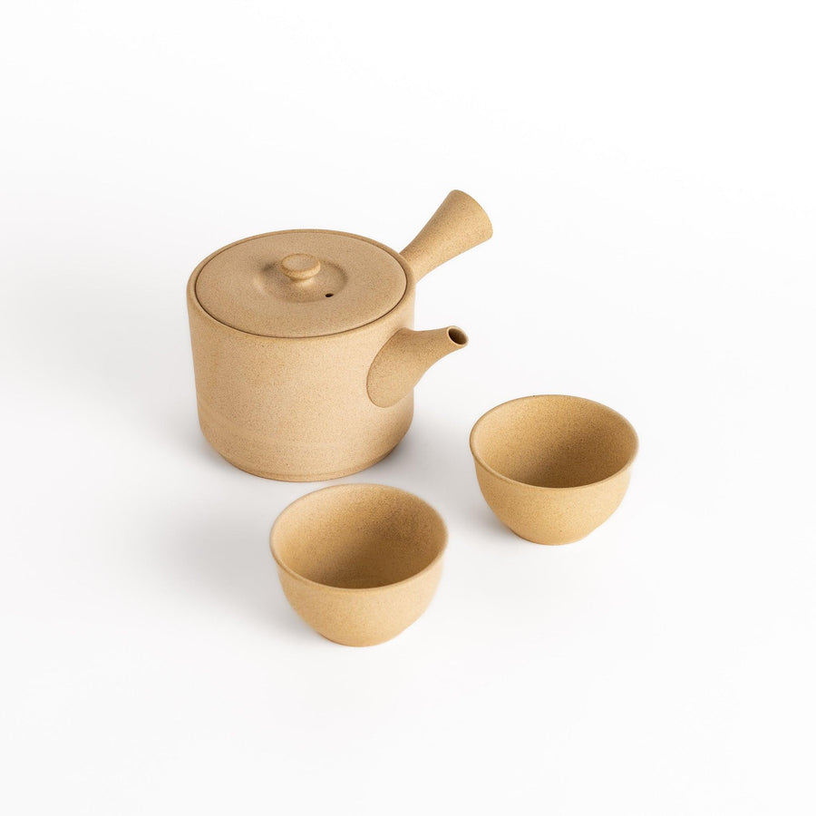 Large beige tea set with round teapot and matching bowls ideal for enjoying tea in elegant style.