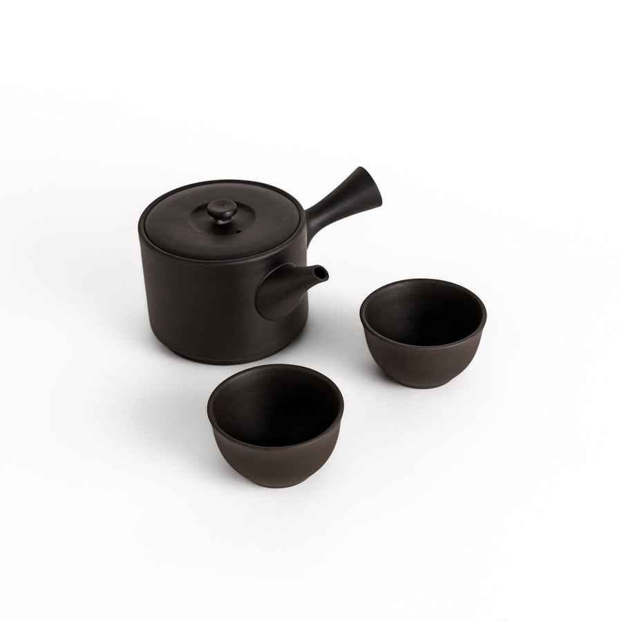 Large black tea set with round teapot and bowls perfect for stylish tea gatherings.