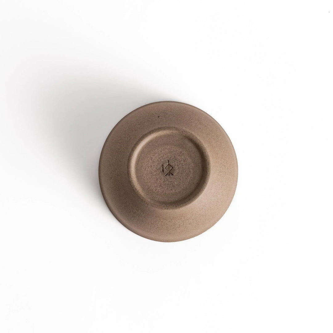Bottom view of a gray ceramic teacup, showcasing its base and craftsmanship details.