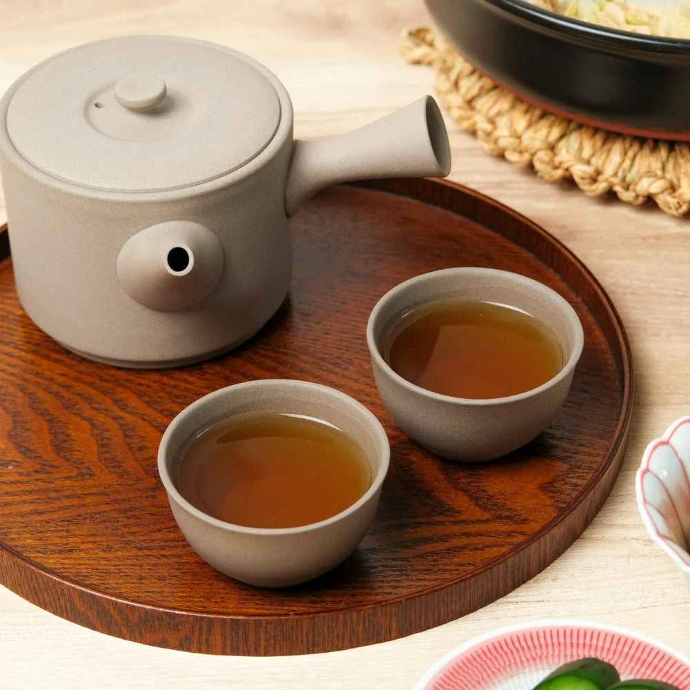Large Cloud Whisper gray tea set with side-handle teapot and cups on a wooden tray, perfect for serving warm tea.