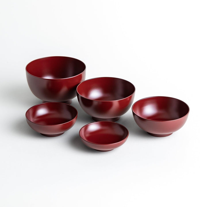 Set of five nested lacquer bowls with footed bases used in Japanese oryoki meals for formal mindful dining.