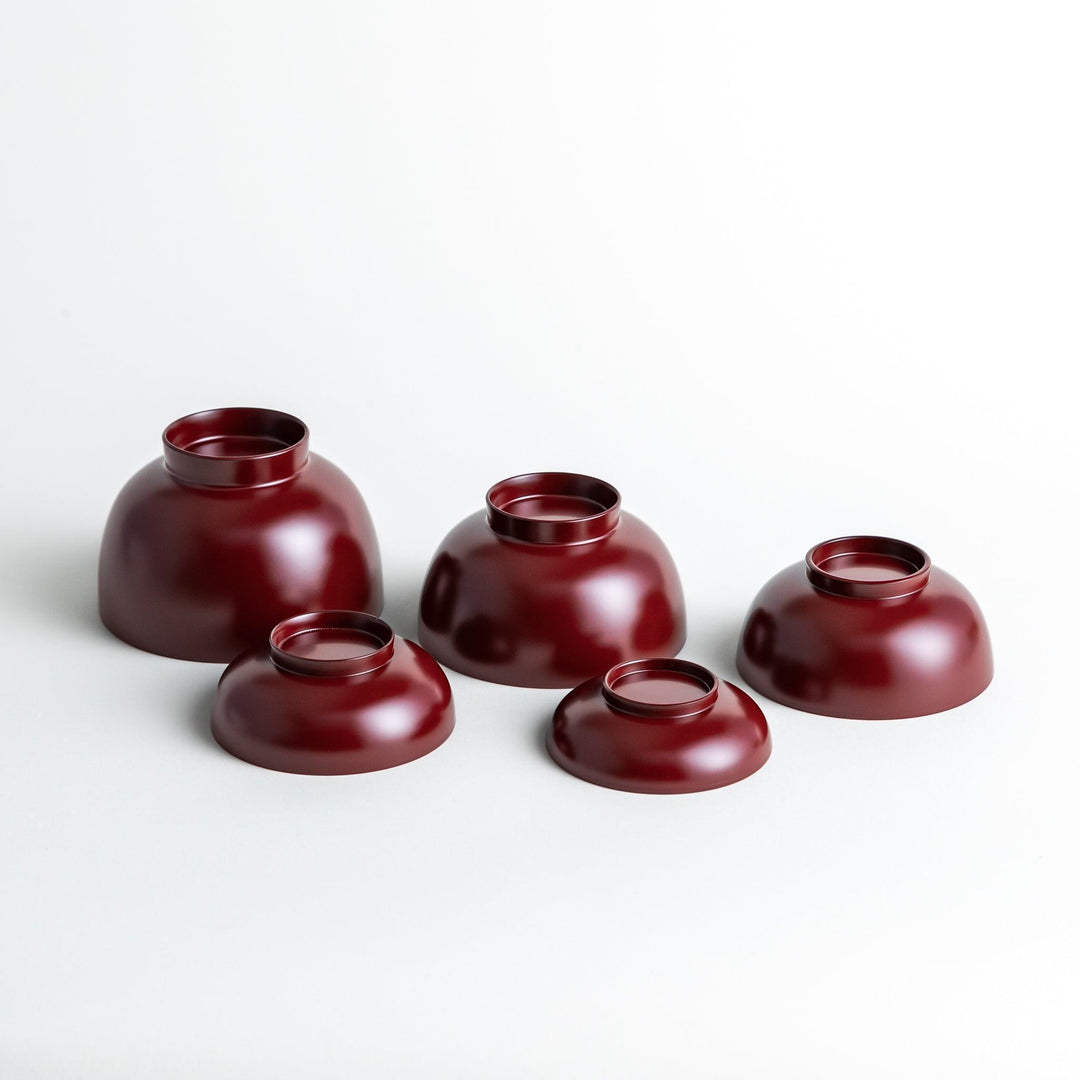 Set of five nested lacquer bowls with footed bases used in Japanese oryoki meals for formal mindful dining.
