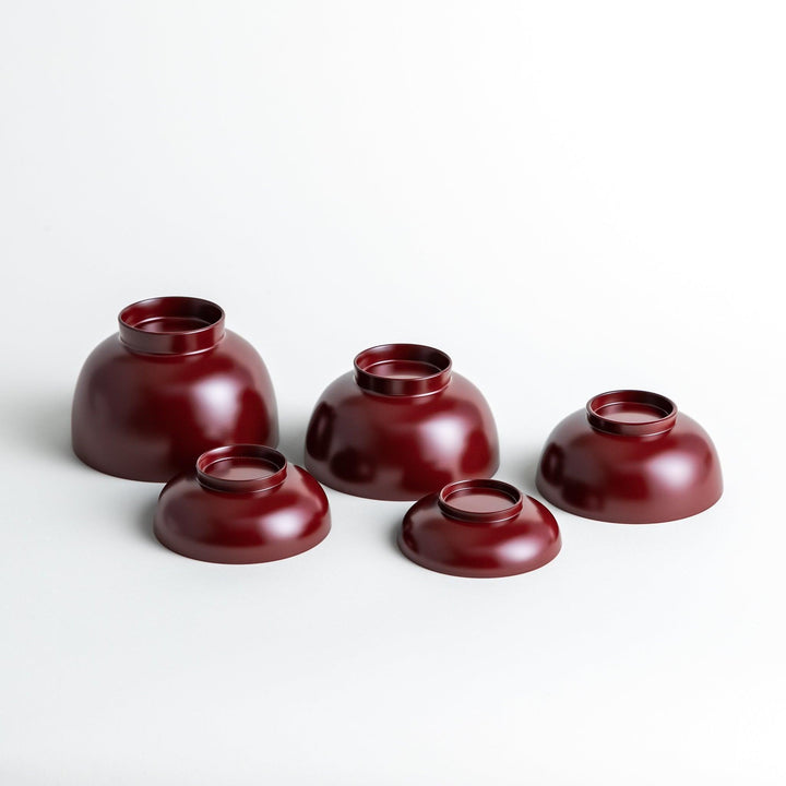 Set of five nested lacquer bowls with footed bases used in Japanese oryoki meals for formal mindful dining.