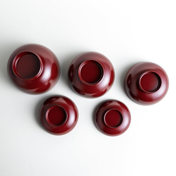 Set of five nested lacquer bowls with footed bases used in Japanese oryoki meals for formal mindful dining.
