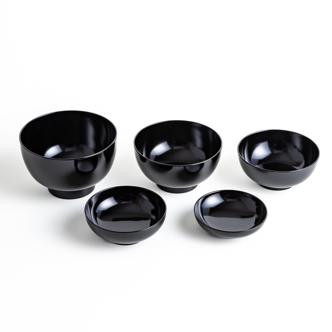 Set of five nested lacquer bowls with footed bases used in Japanese oryoki meals for formal mindful dining.