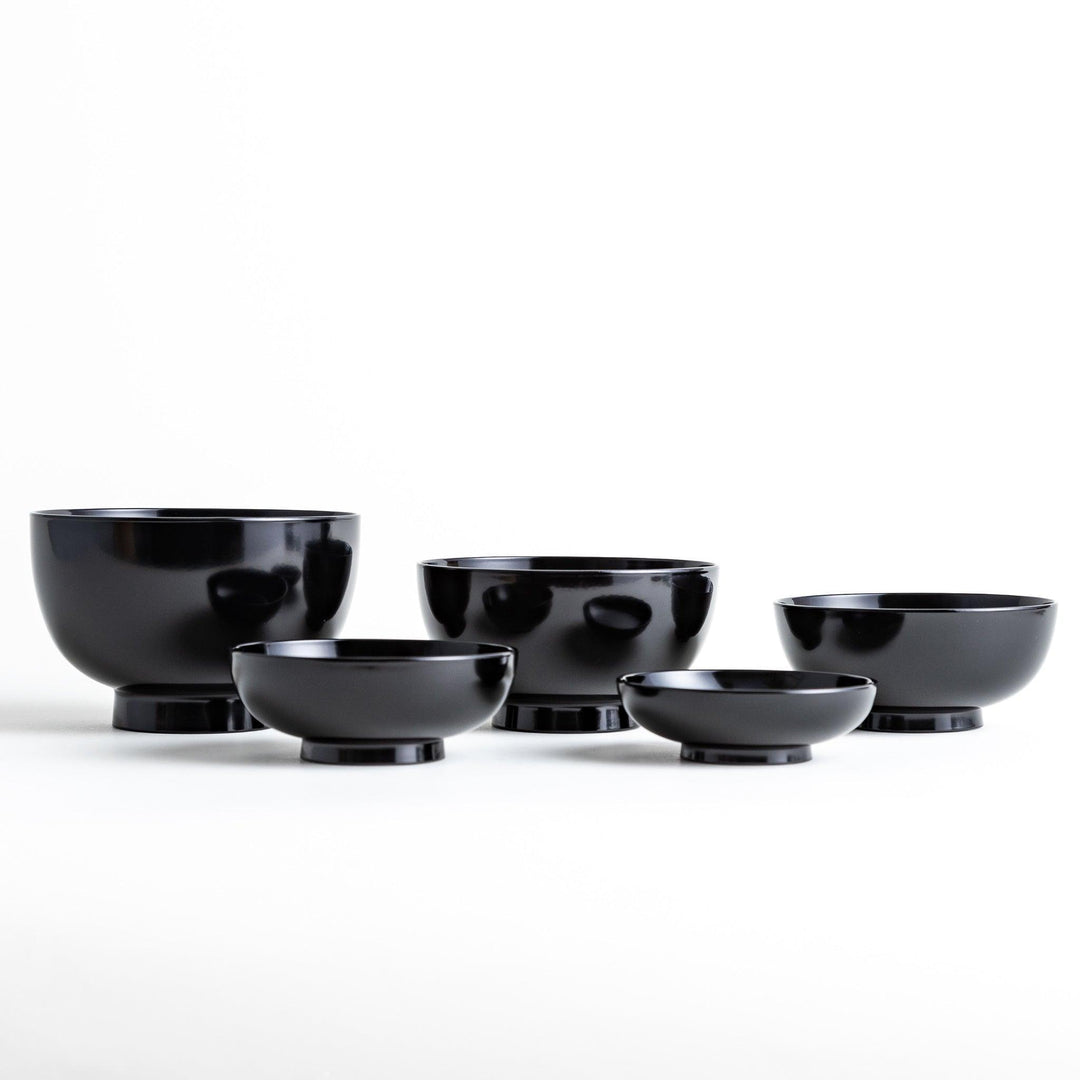 Set of five nested lacquer bowls with footed bases used in Japanese oryoki meals for formal mindful dining.