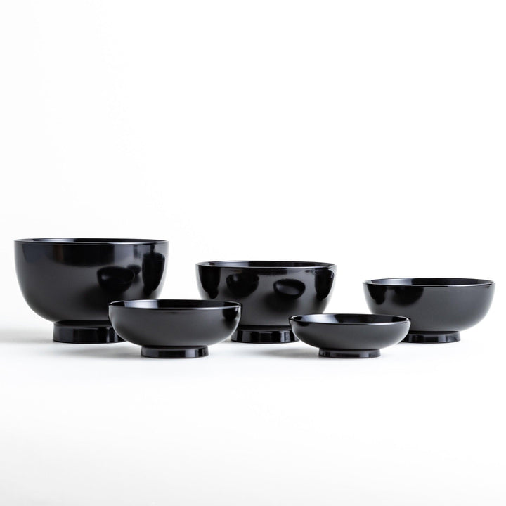 Set of five nested lacquer bowls with footed bases used in Japanese oryoki meals for formal mindful dining.