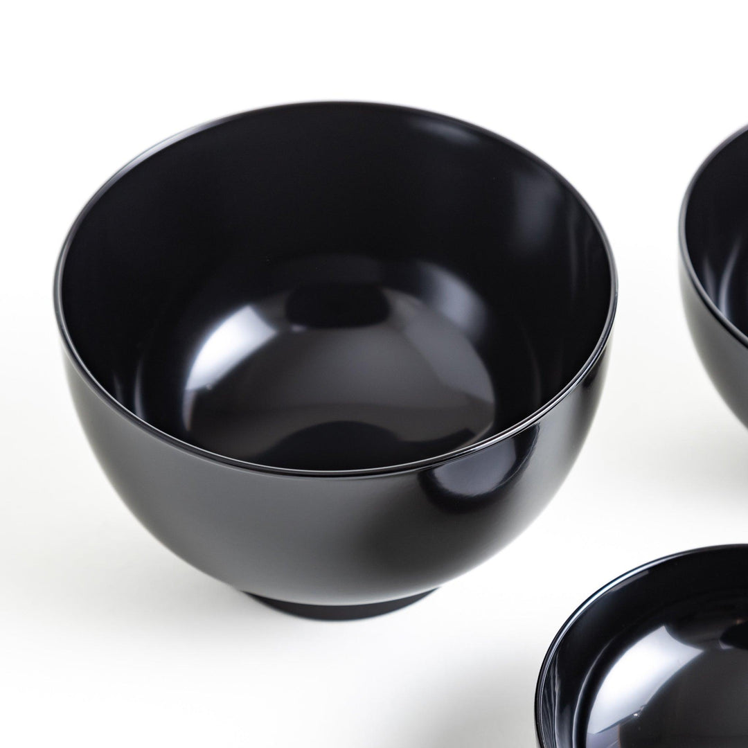 Set of five nested lacquer bowls with footed bases used in Japanese oryoki meals for formal mindful dining.