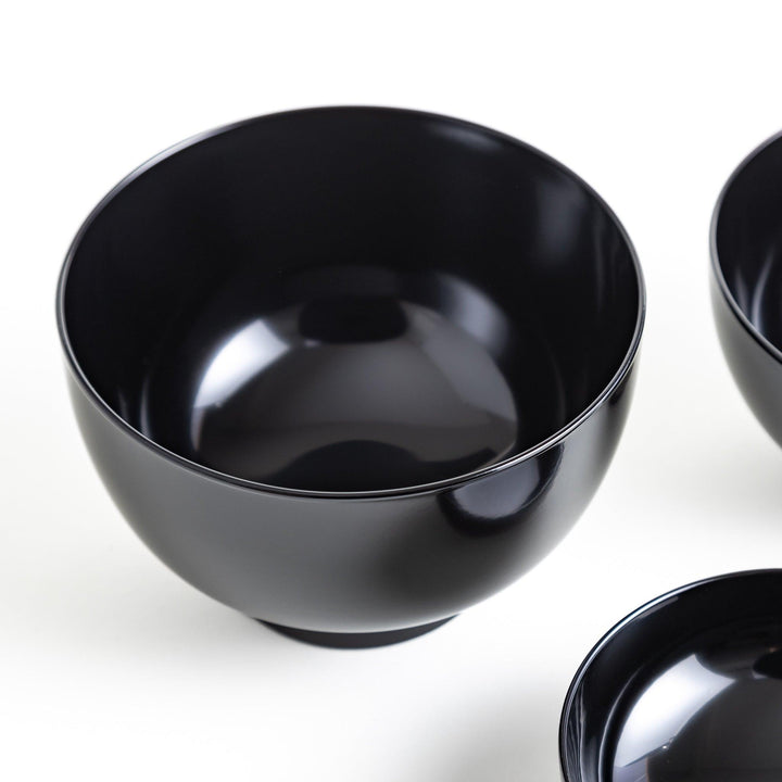 Set of five nested lacquer bowls with footed bases used in Japanese oryoki meals for formal mindful dining.