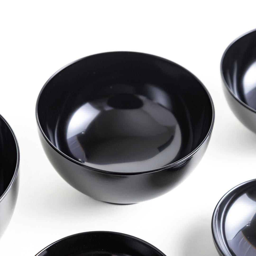 Set of five nested lacquer bowls with footed bases used in Japanese oryoki meals for formal mindful dining.