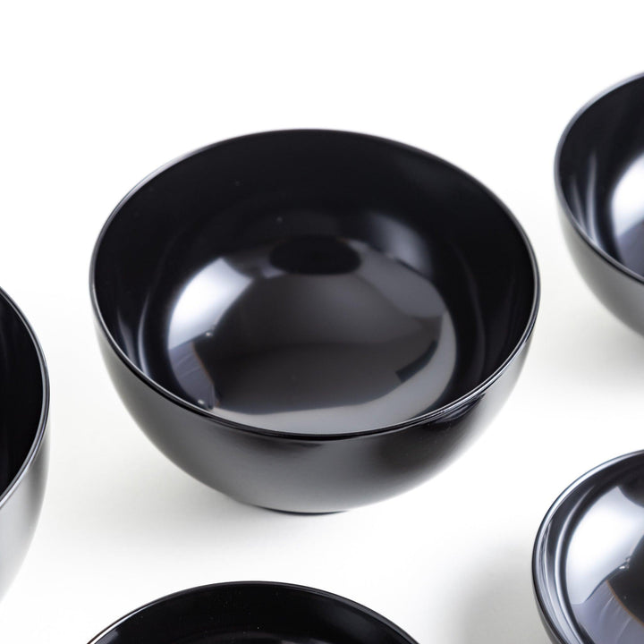 Set of five nested lacquer bowls with footed bases used in Japanese oryoki meals for formal mindful dining.