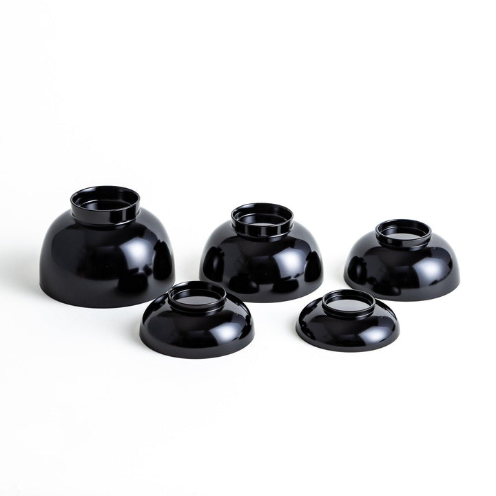 Set of five nested lacquer bowls with footed bases used in Japanese oryoki meals for formal mindful dining.