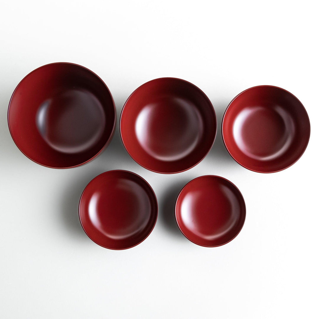 Set of five nested lacquer bowls with footed bases used in Japanese oryoki meals for formal mindful dining.