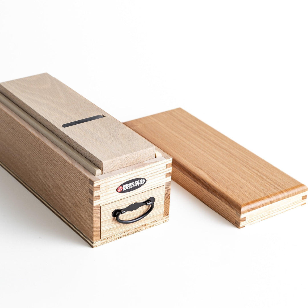 Large wooden katsuobushi shaver box with sliding drawer and lid and colorful Japanese artwork packaging.
