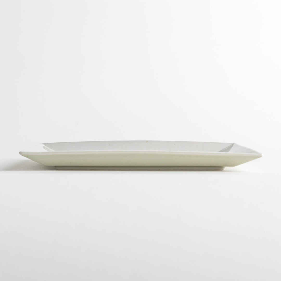 A rectangular ceramic plate with blue horizontal stripes, simple and elegant design.