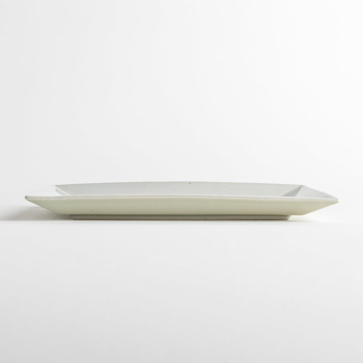 A rectangular ceramic plate with blue horizontal stripes, simple and elegant design.