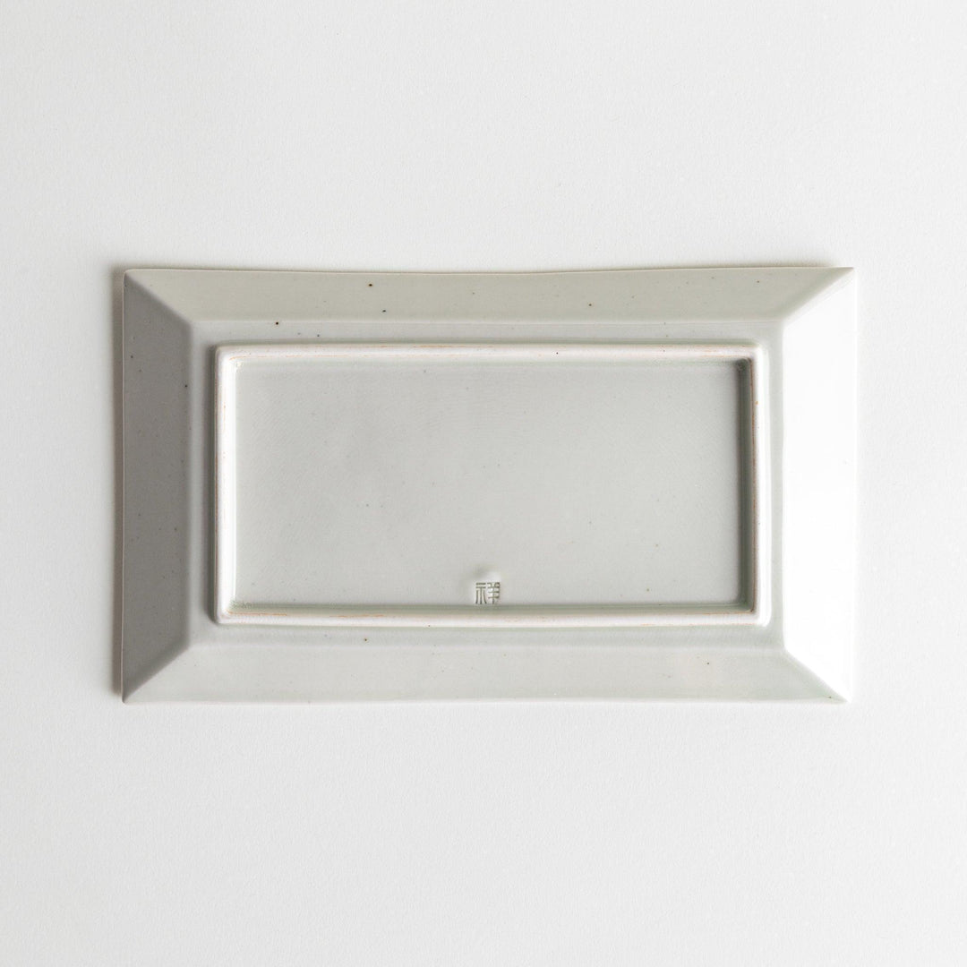 A rectangular ceramic plate with blue horizontal stripes, simple and elegant design.