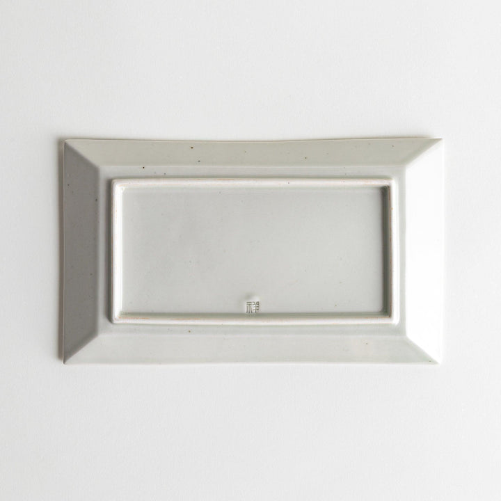 A rectangular ceramic plate with blue horizontal stripes, simple and elegant design.