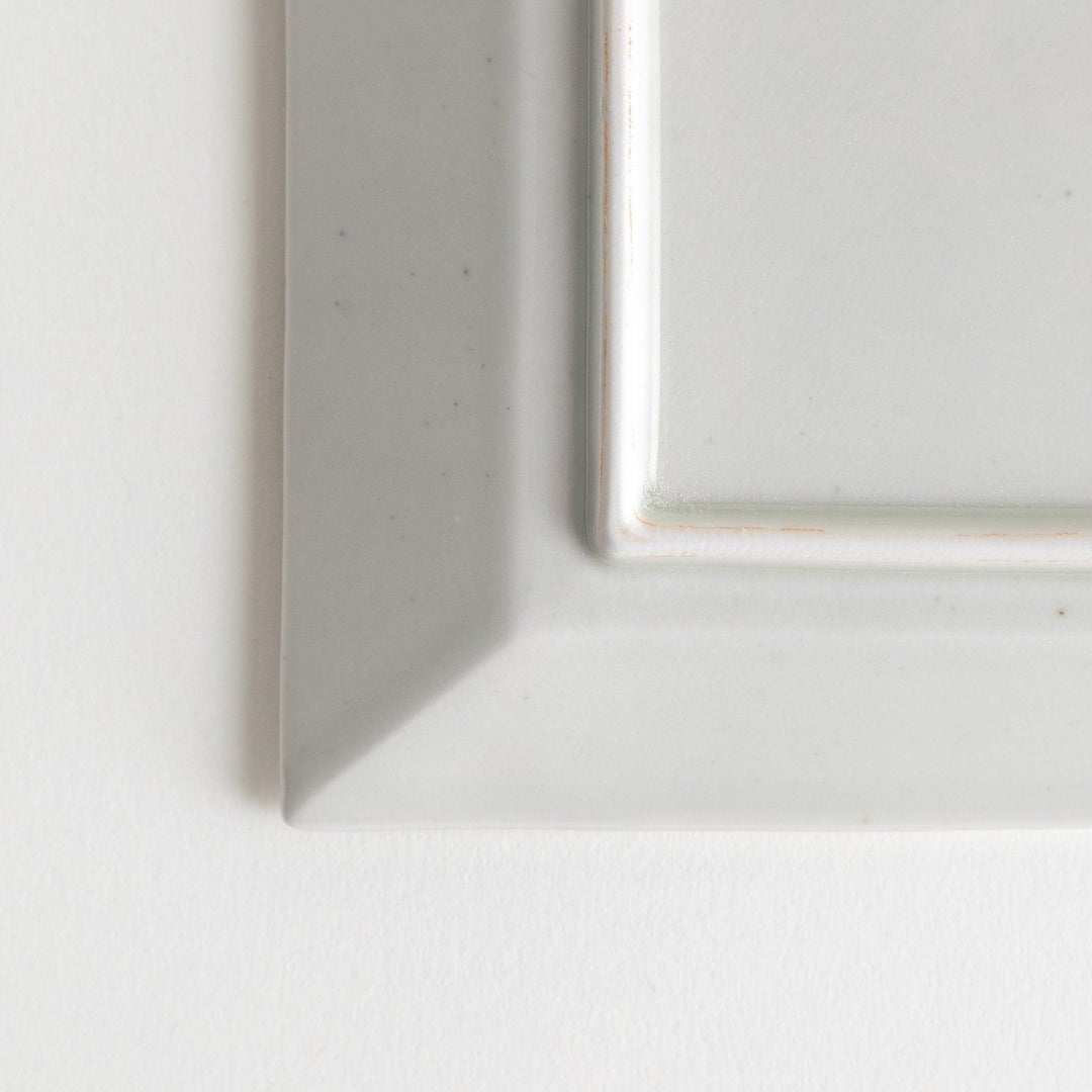 A rectangular ceramic plate with blue horizontal stripes, simple and elegant design.