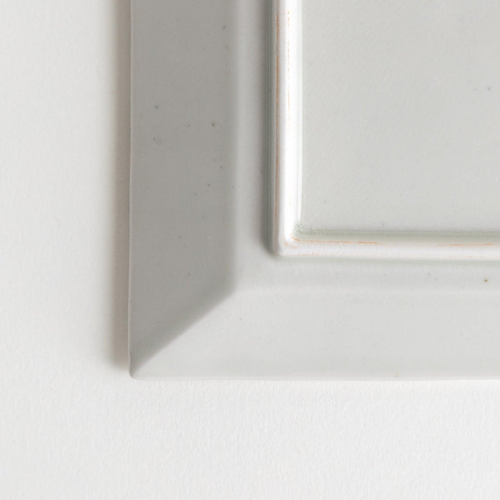 A rectangular ceramic plate with blue horizontal stripes, simple and elegant design.