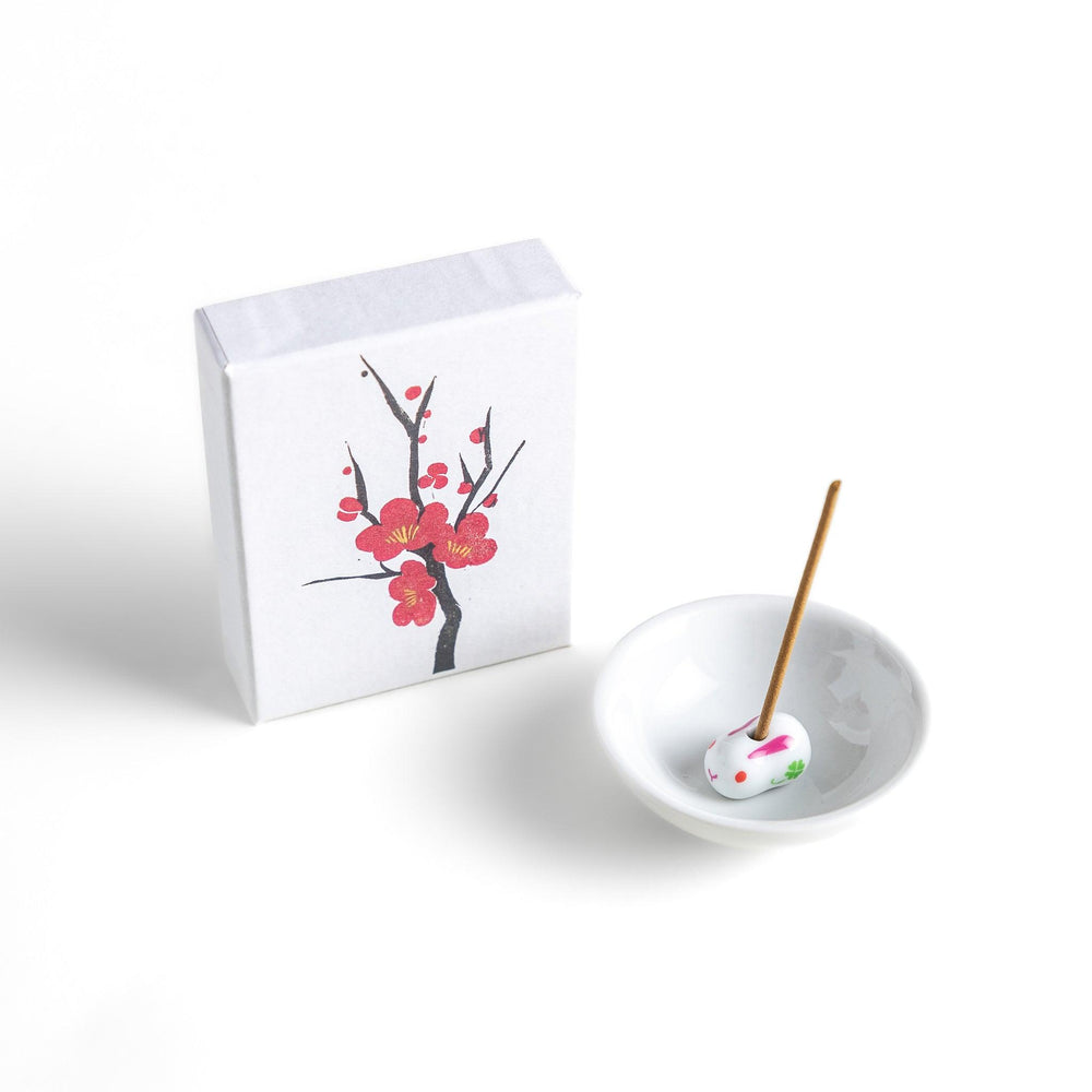 Japanese plum blossom incense with warm brown sticks in illustrated box offering sweet subtle floral fragrance.